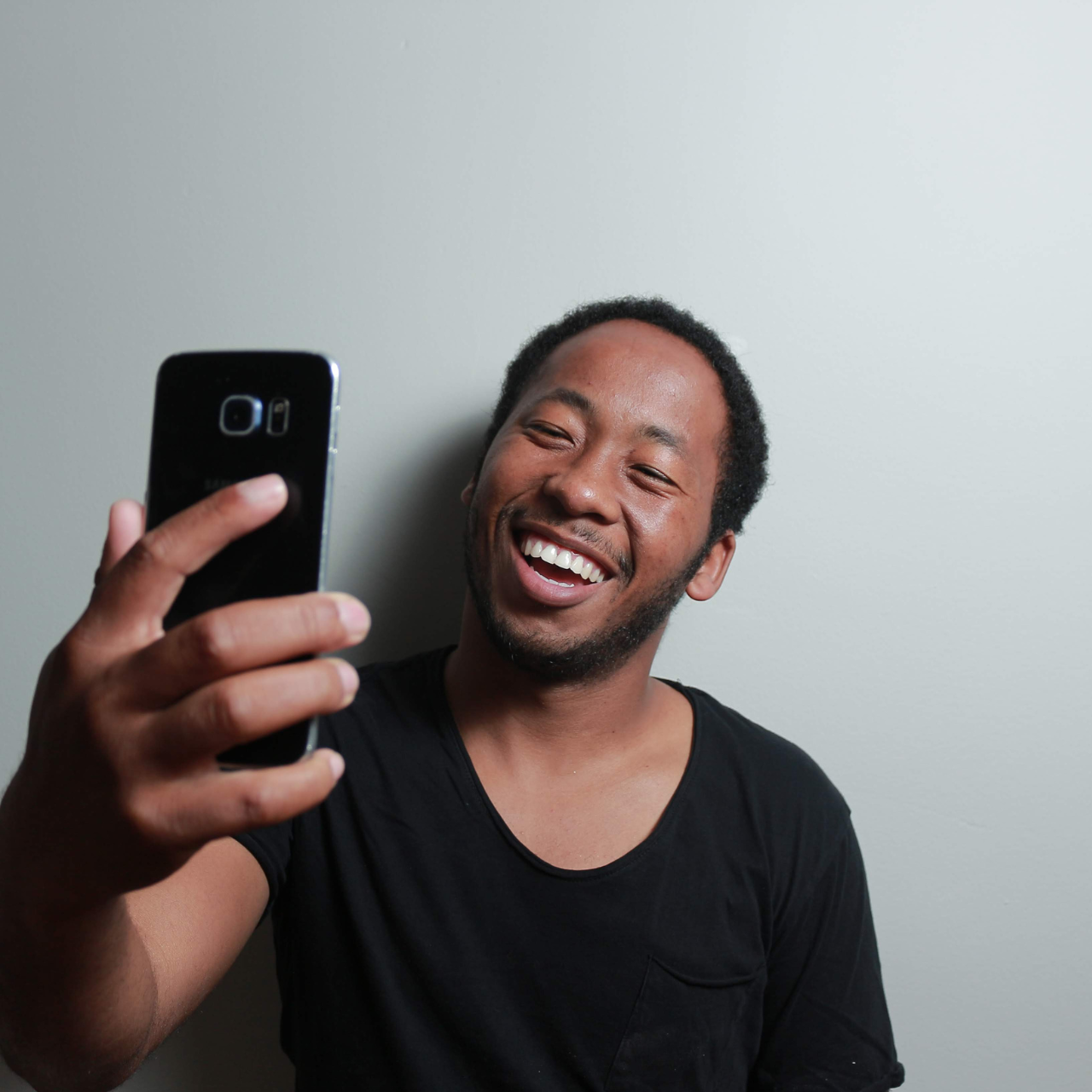 a person taking a selfie with his mobile