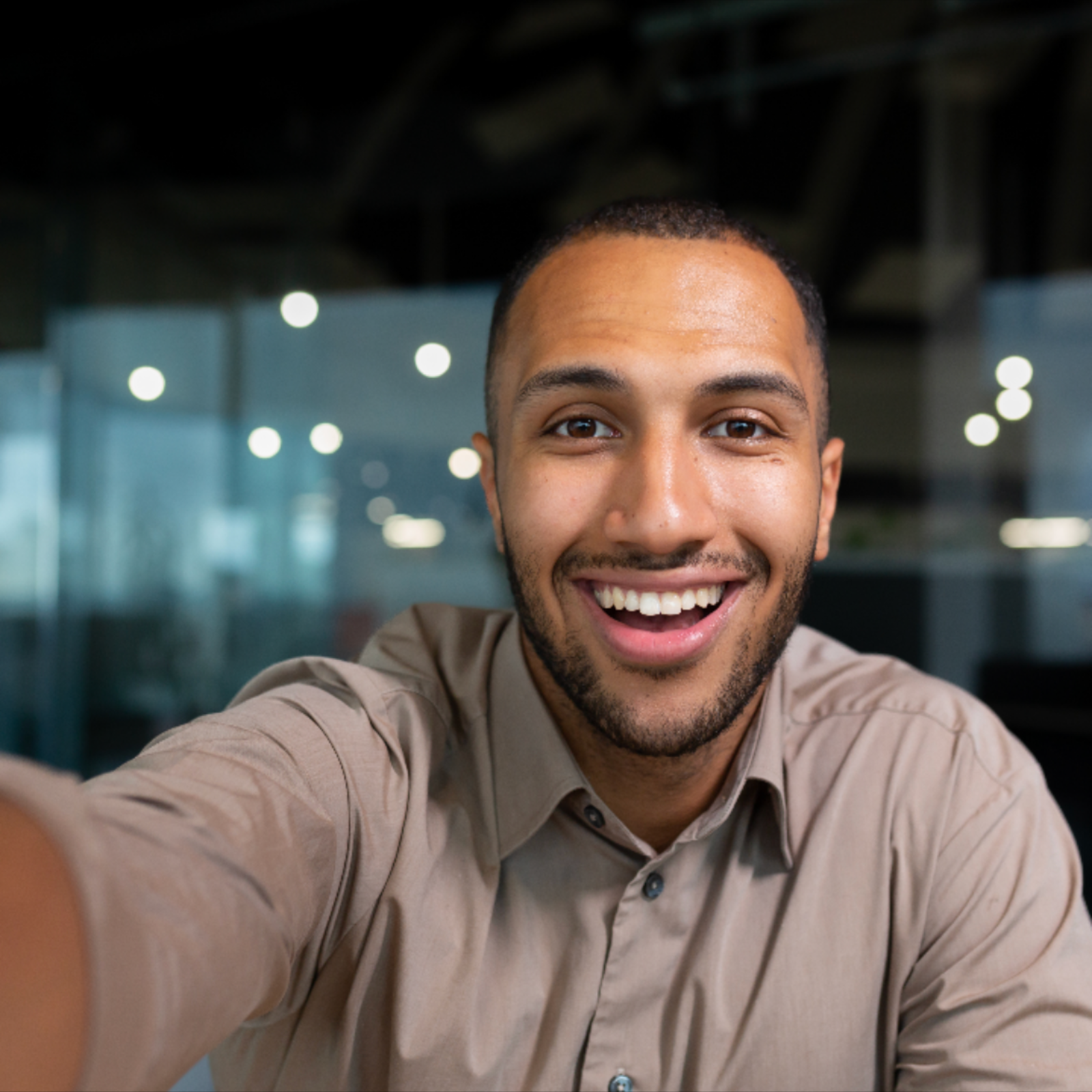 a person smiling while taking a selfie 