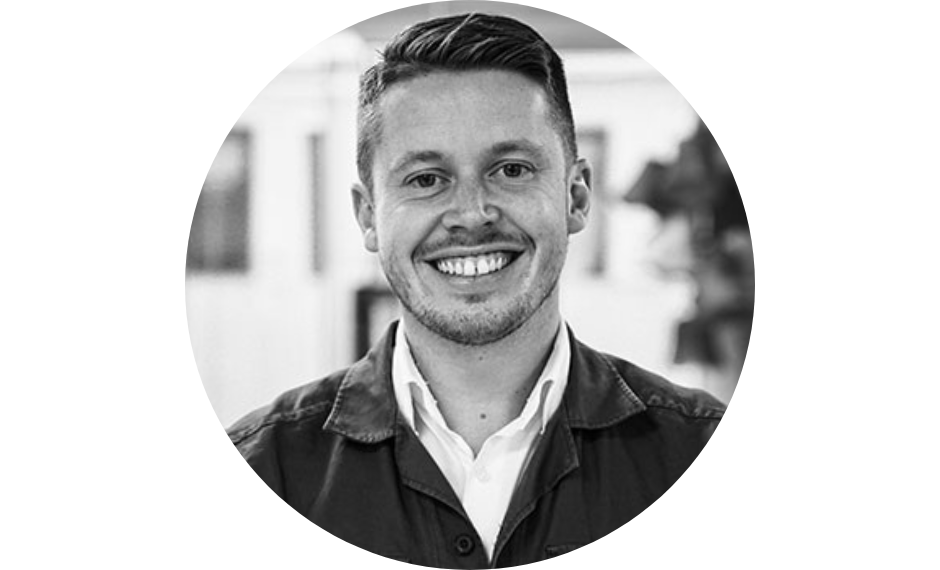 Niklas Busk with a bright smile standing at the office 